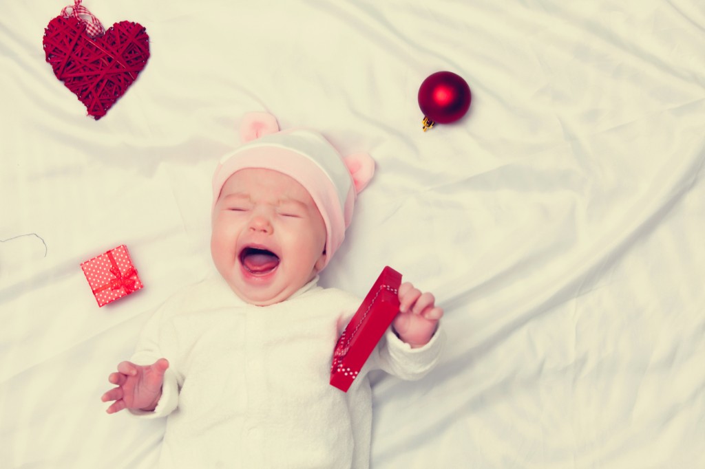 Little baby with christmas gifts around
